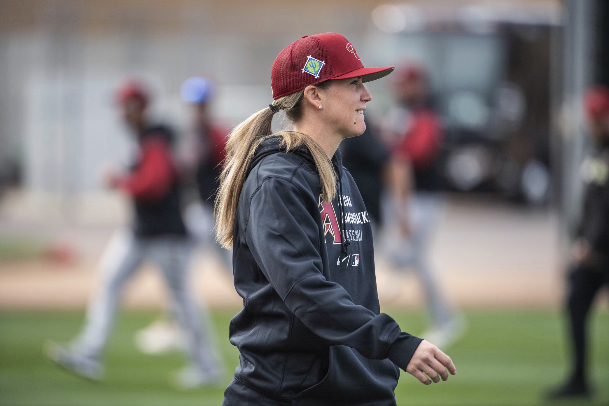 In a photo provided by the Arizona Diamondbacks, Ronnie Gajown watches the baseball team's minor league minicamp at Salt River Fields in February 2022 in Scottsdale, Ariz. Gajownik has been hired as manager of the Hillsboro Hops, becoming the first woman to manage a minor league Class High-A team, the Arizona Diamondbacks announced Friday, Jan. 20, 2023. 