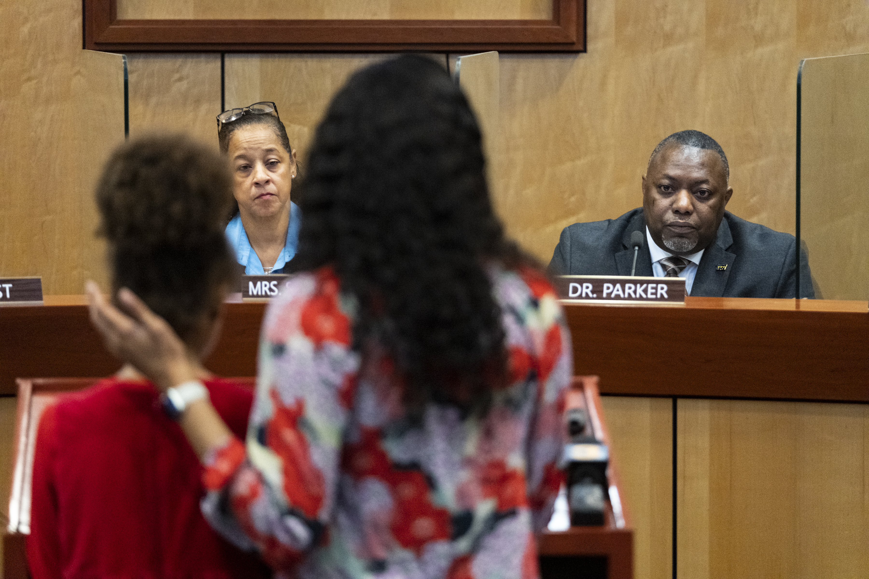 Teacher Djifa Lee, center, stands with her daughter as she speaks in front of the Newport News School Board on Tuesday. As kids' behavior reaches crisis points after the stress and isolation of pandemic shutdowns, many schools are facing pressure to rethink discipline approaches. 