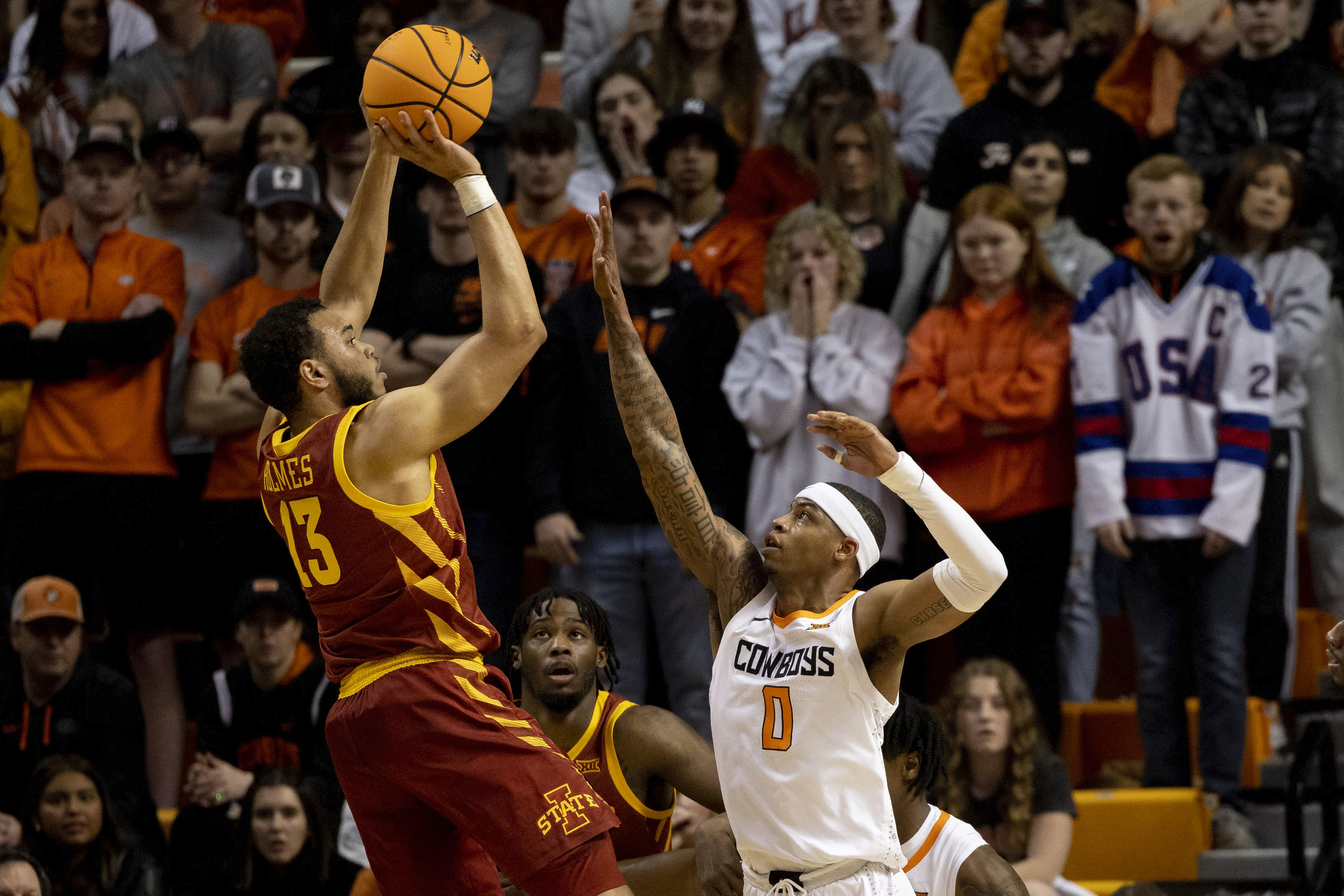 Iowa State's Jaren Holmes (13) shoots over Oklahoma State's Avery Anderson III (0) in the first half of the NCAA college basketball game in Stillwater, Okla., Saturday, Jan. 21, 2023. 