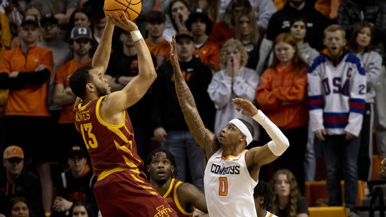 Iowa State's Jaren Holmes (13) shoots over Oklahoma State's Avery Anderson III (0) in the first half of the NCAA college basketball game in Stillwater, Okla., Saturday, Jan. 21, 2023.
