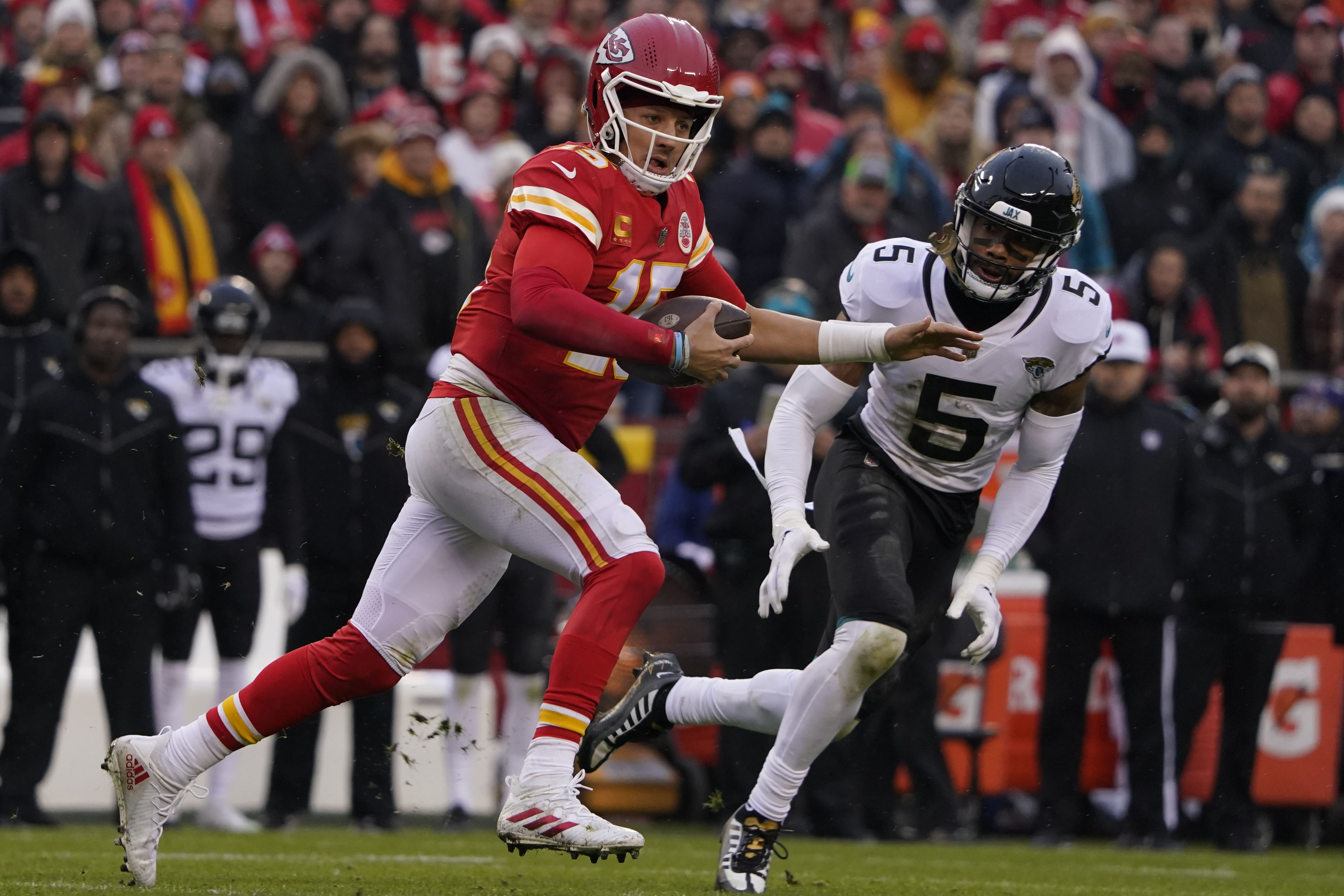 Kansas City Chiefs quarterback Patrick Mahomes (15) runs out of the pocket as Jacksonville Jaguars safety Andre Cisco (5) defends during the first half of an NFL divisional round playoff football game, Saturday, Jan. 21, 2023, in Kansas City, Mo. Mahomes was injured after the play. 