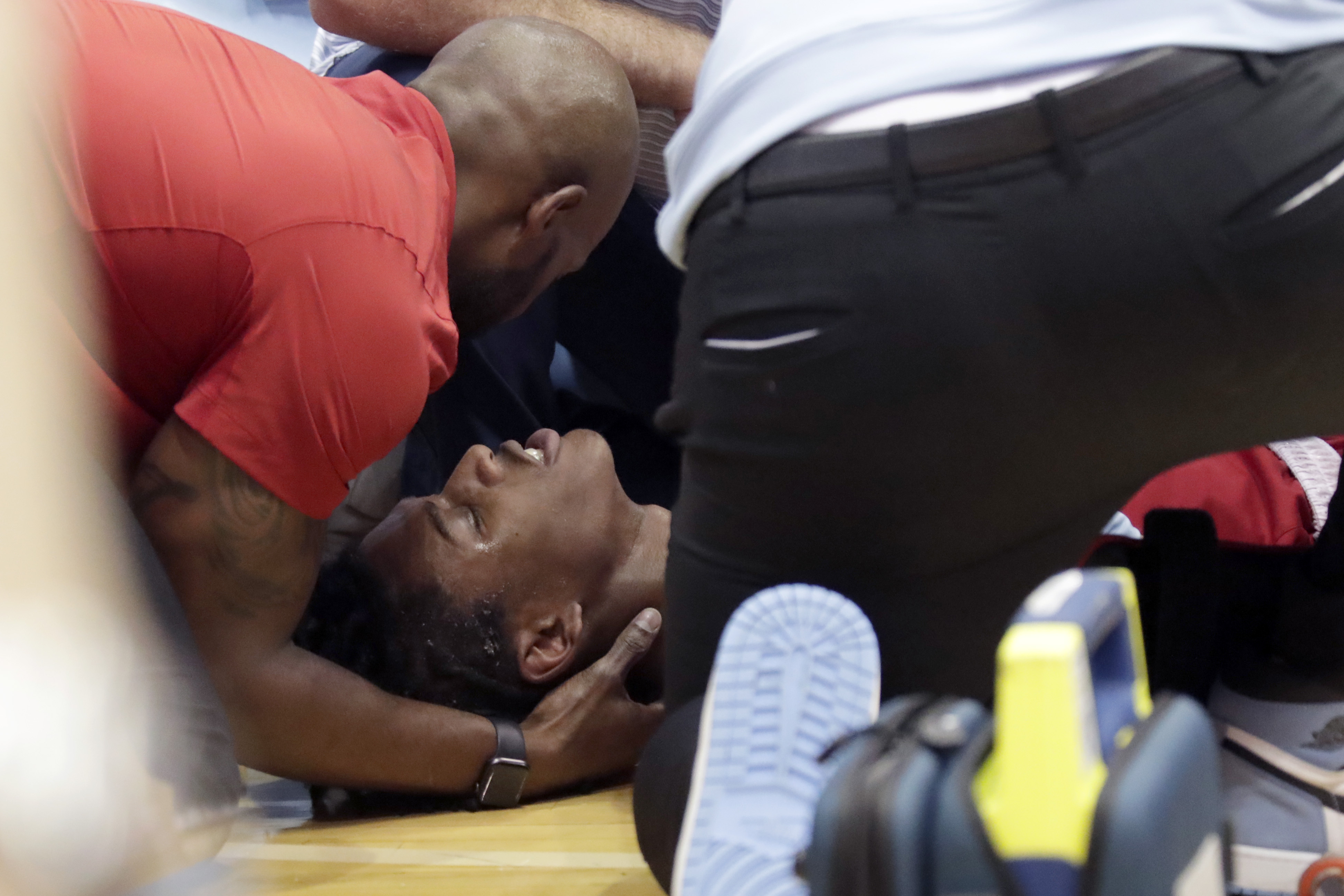 North Carolina State player Terquavion Smith, bottom, is tended by medical personnel after he crashed to the floor after being fouled during the second half of an NCAA college basketball game against North Carolina, Saturday, Jan. 21, 2023, in Chapel Hill, N.C. 