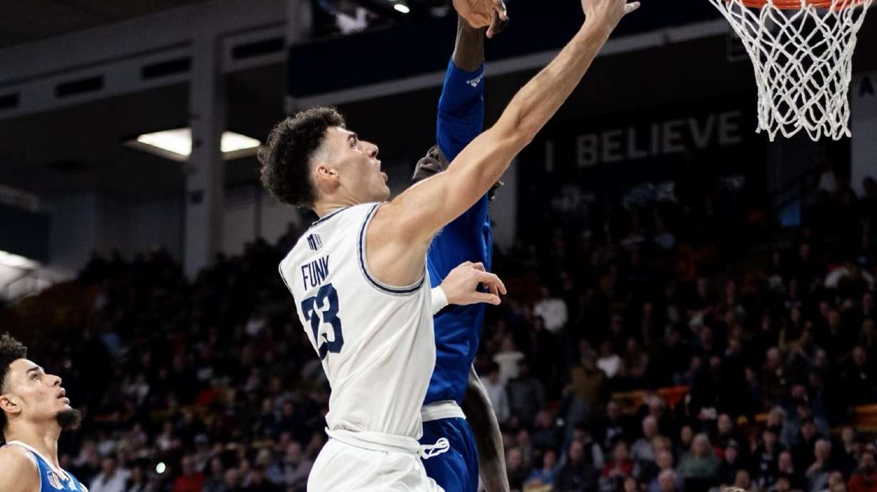 Utah State's Taylor Funk drives to the basket against a San Jose State defender in Logan on Jan. 21, 2023.