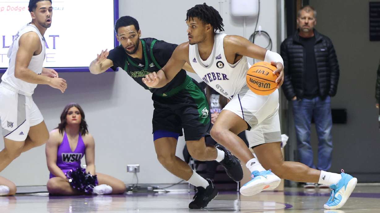 Weber State forward Dillon Jones drives against a Sacramento State defender in a game the Wildcats won 50-48 on Jan. 21, 2023.