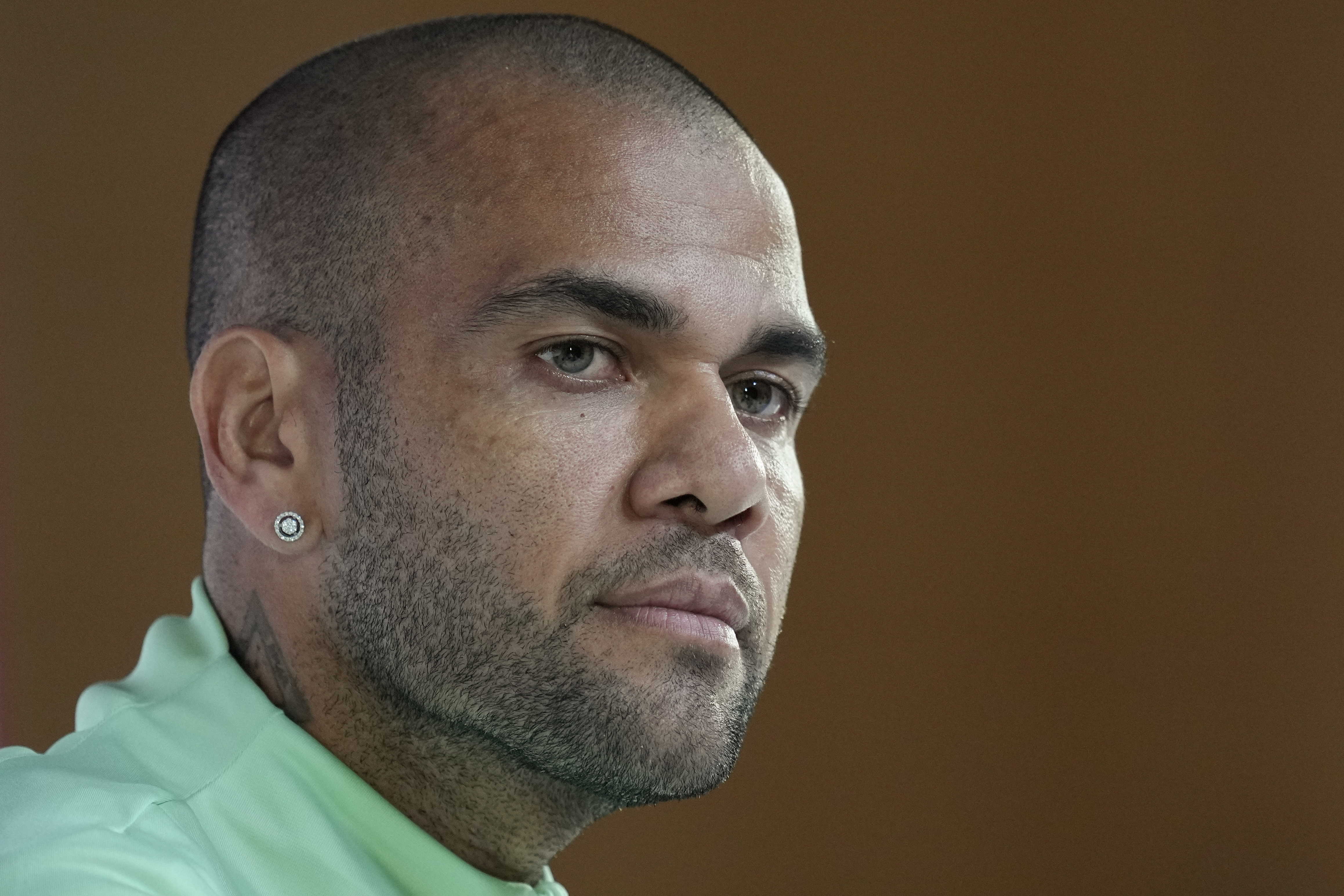 FILE - Brazil's Dani Alves listens to a question during a press conference on the eve of the group G of World Cup soccer match between Brazil and Cameroon in Doha, Qatar, Thursday, Dec. 1, 2022. Brazilian soccer player Dani Alves has been arrested after being accused of sexually abusing a woman in Barcelona it was reported on Friday, Jan. 20, 2023. Police say the alleged act took place on Dec. 31 at a night club in Barcelona. Alves will now go before a judge. The judge will decide on the charges. 