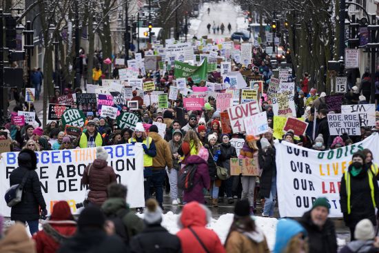 Protesters make their way to the Wisconsin Capitol Rotunda during a march supporting overturning Wisconsin's near total ban on abortion Sunday in Madison, Wis.