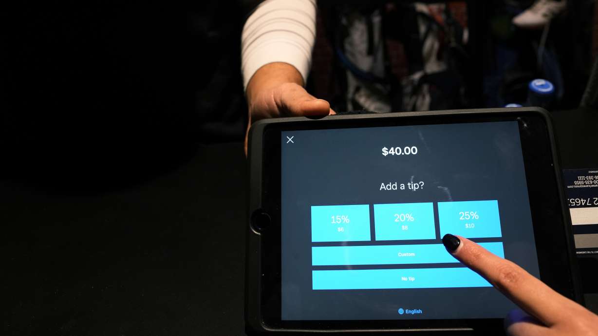 A tipping option is displayed on a card reader tablet at X-Golf indoor golf in Glenview, Ill., Friday. Tipping fatigue, it seems, is swarming America.