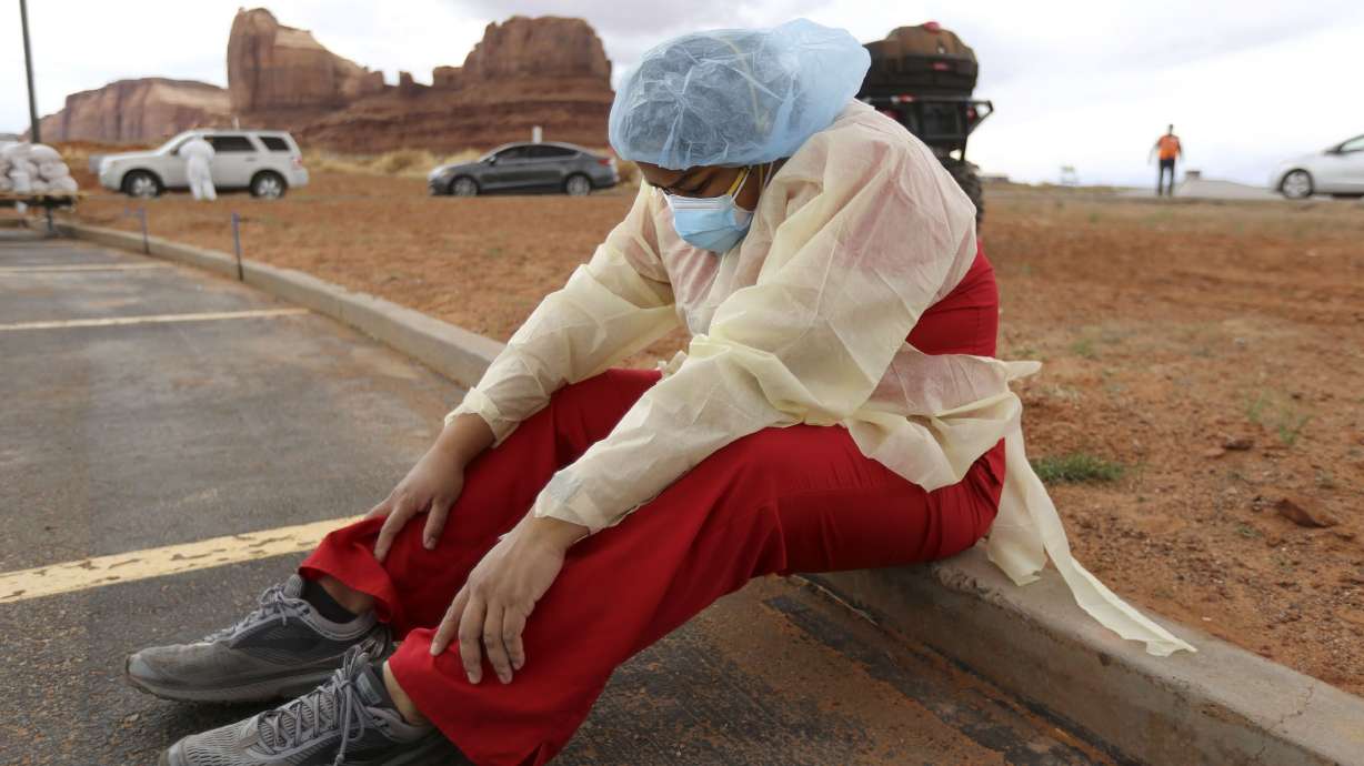 Denise Begaye, an X-ray technician with the Monument Valley Health Center, takes a break from COVID-19 testing outside of the center in Oljato-Monument Valley, San Juan County on April 16, 2020. The Navajo Nation has largely ended one of the longest-standing mask mandates in the United States.