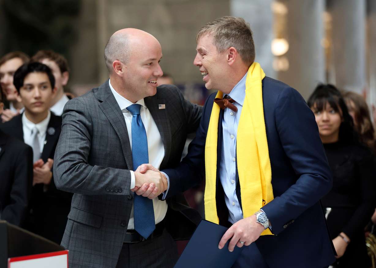 Gov. Spencer Cox, left, shakes hands with Royce Van Tassell, Utah Association of Public Charter Schools executive director, during a rally to support school choice, hosted by the Utah Association of Public Charter Schools, at the Capitol in Salt Lake City on Monday. Nearly 1,000 charter school students from Logan to St. George on Monday descended upon the Utah Capitol Rotunda to rally and advocate for school choice as controversial bill makes its way through the legislature.