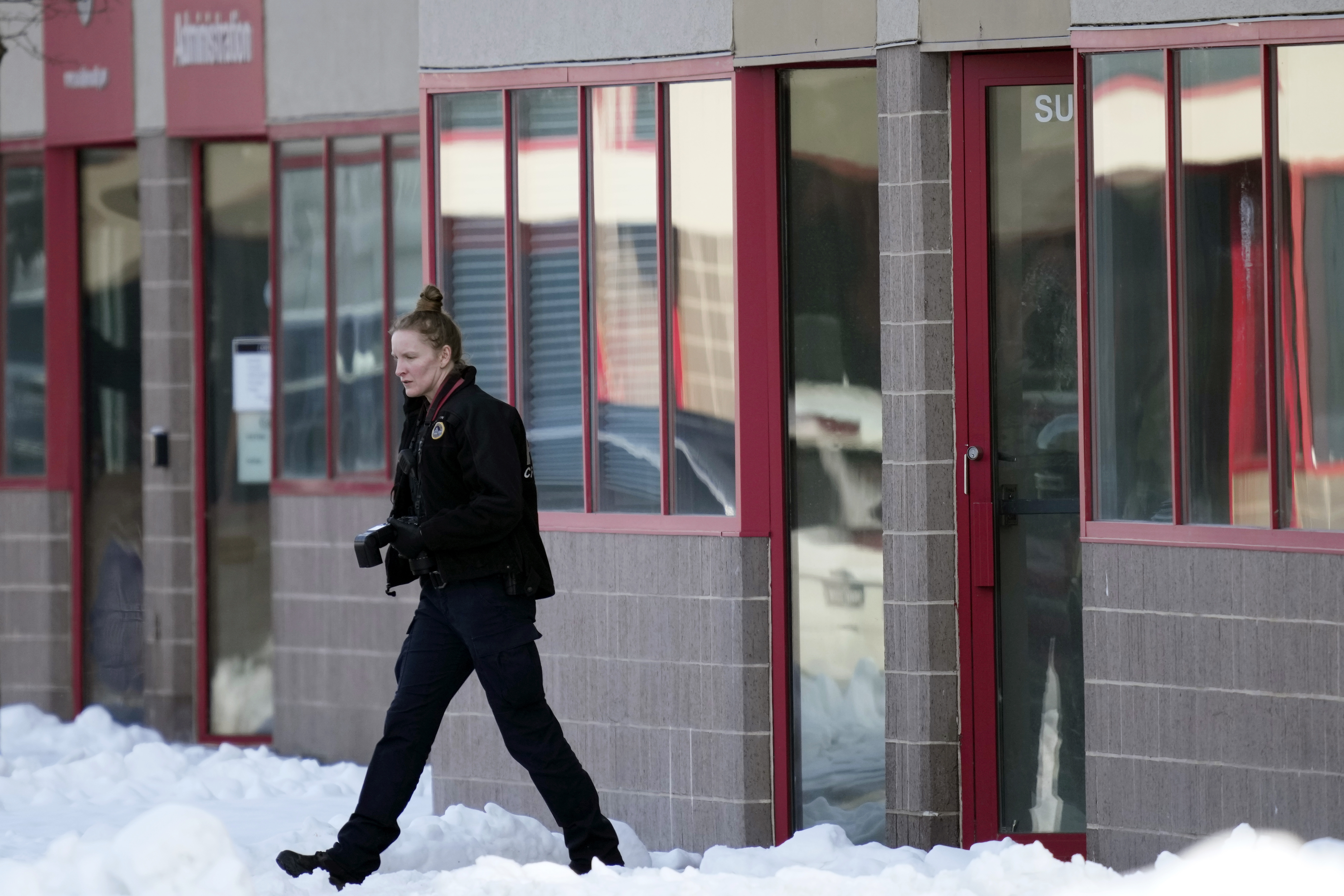 A law enforcement officer exits the Starts Right Here building, Monday in Des Moines, Iowa. Police say two students were killed and a teacher was injured in a shooting at the Des Moines school on the edge of the city's downtown.