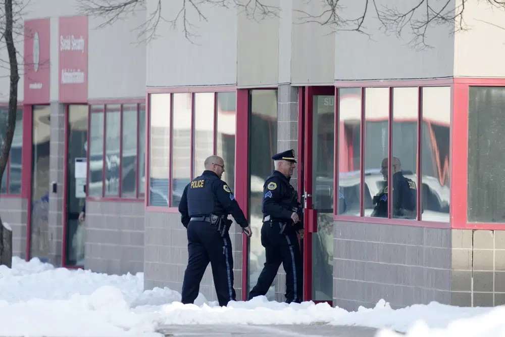 Law enforcement officers enter the Starts Right Here building, Monday in Des Moines, Iowa. Police say two students were killed and a teacher was injured in a shooting at the Des Moines school on the edge of the city's downtown.