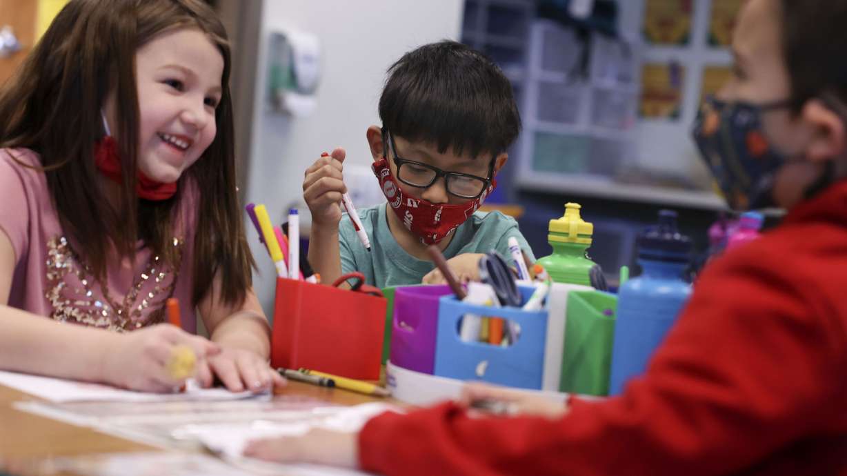 Kindergartners Trinity Trujillo, left, Carlos Meija and Robert Espinoza attend class at Woodrow Wilson Elementary School in Salt Lake City on Feb. 25, 2022. Legislators are debating the latest version of SB193, which seeks to provide more state funding to increase the number of Utah public schools that offer full-day kindergarten.