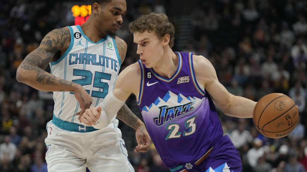 Utah Jazz forward Lauri Markkanen (23) drives around Charlotte Hornets forward P.J. Washington (25) during the first half of an NBA basketball game Monday, Jan. 23, 2023, in Salt Lake City. (AP Photo/Rick Bowmer)