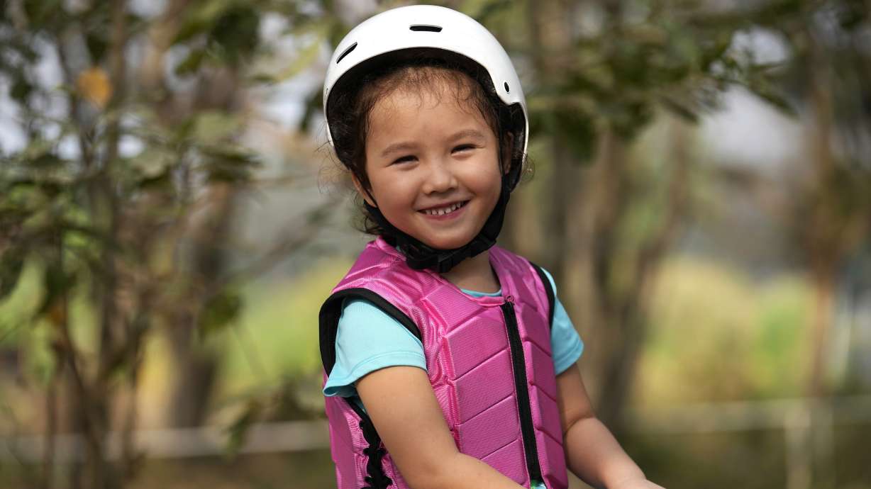 Rylae-Ann Poulin smiles as she learns to ride a horse in Bangkok, Thailand, Jan. 14. She was among the first to benefit from a new way of delivering gene therapy — directly into the brain — that experts believe holds great promise for treating a host of brain disorders.