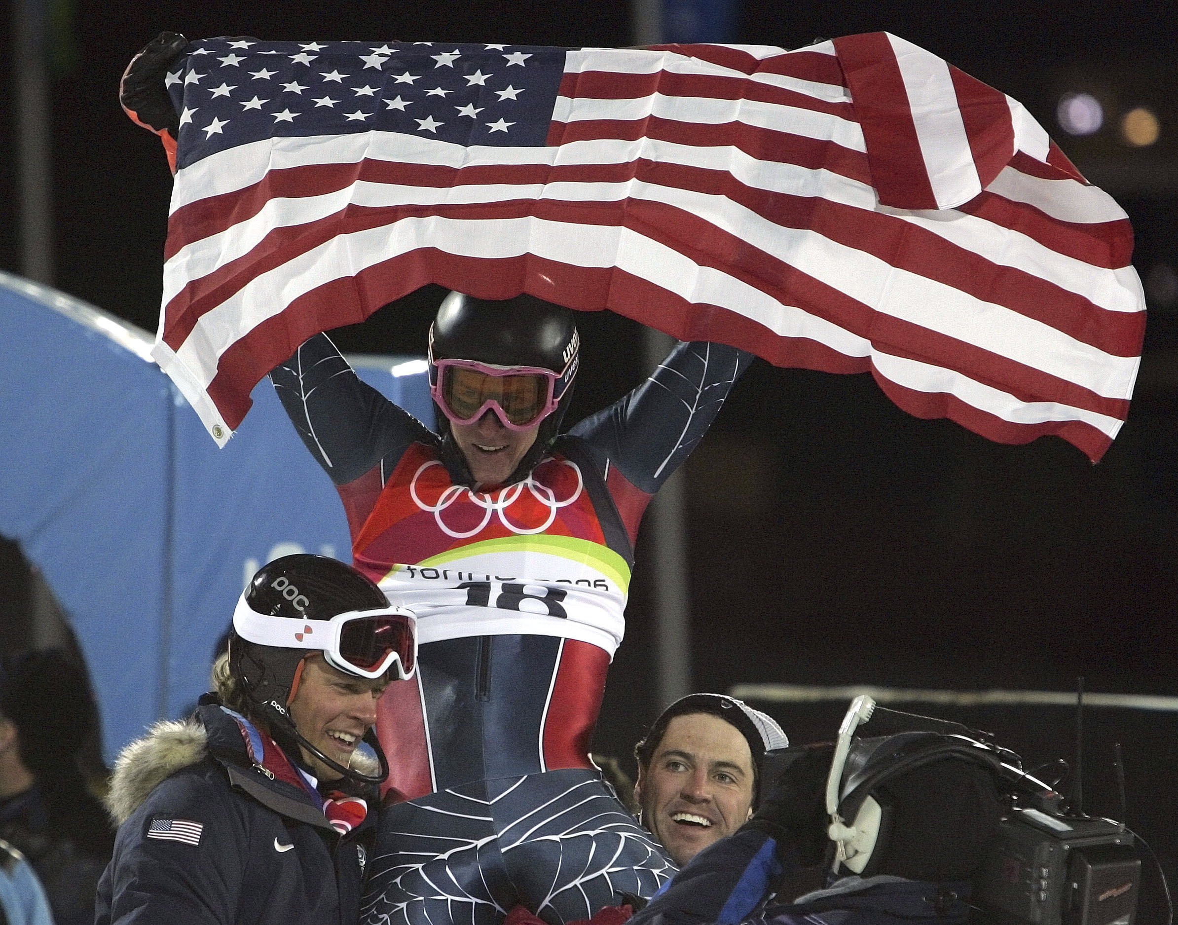 FILE - Ted Ligety of the United States, center, is chaired by teammates as he celebrates after winning the gold medal after the Men's Combined at the Turin 2006 Winter Olympic Games in Sestriere Colle, Italy, Tuesday, Feb. 14, 2006. Mikaela Shiffrin's record 83rd World Cup victory Tuesday, Jan. 24, 2023 is only the latest exploit by an American team that has been producing success after success on the circuit since Daron Rahlves and Bode Miller started it all off more than 20 years ago. 