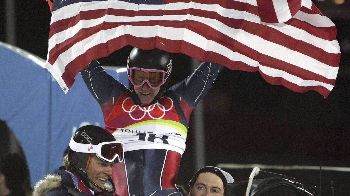FILE - Ted Ligety of the United States, center, is chaired by teammates as he celebrates after winning the gold medal after the Men's Combined at the Turin 2006 Winter Olympic Games in Sestriere Colle, Italy, Tuesday, Feb. 14, 2006. Mikaela Shiffrin's record 83rd World Cup victory Tuesday, Jan. 24, 2023 is only the latest exploit by an American team that has been producing success after success on the circuit since Daron Rahlves and Bode Miller started it all off more than 20 years ago.