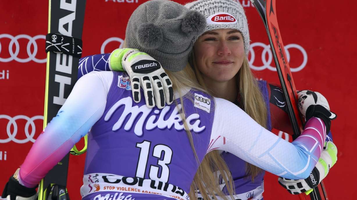 FILE - United States' Mikaela Shiffrin, third place in an alpine ski, women's World Cup downhill, right, is hugged by second-placed United States' Lindsey Vonn, in Cortina D'Ampezzo, Italy, In this Friday, Jan. 19, 2018 file photo. Mikaela Shiffrin has had a World Cup skiing career like no other woman. Shiffrin raced to a record-breaking 83rd win Tuesday, Jan. 24, 2023.