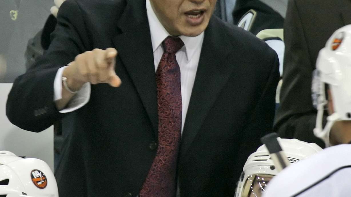 FILE - New York Islanders coach Ted Nolan talks with his players during a timeout late in the third period of an NHL hockey game against the Pittsburgh Penguins in Pittsburgh, Thursday, Nov. 15, 2007. Nolan finally has his rookie card more than 40 years since making his NHL debut. Better late than never, particularly because it includes a nod to his First Nations heritage.