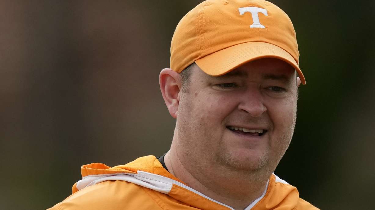 FILE - Tennessee NCAA college football coach Josh Heupel looks on during a team practice session ahead of the 2022 Orange Bowl, Tuesday, Dec. 27, 2022, in Miami Shores, Fla. Heupel guiding the Volunteers to their most wins since 2001 has earned him a very big pay raise. Heupel will make $9 million under the contract extension now good through 2029 announced by Tennessee on Tuesday, Jan. 24, 2023, and signed Jan. 19. That's an increase from the $5 million extension signed last July pushing his deal through 2028.