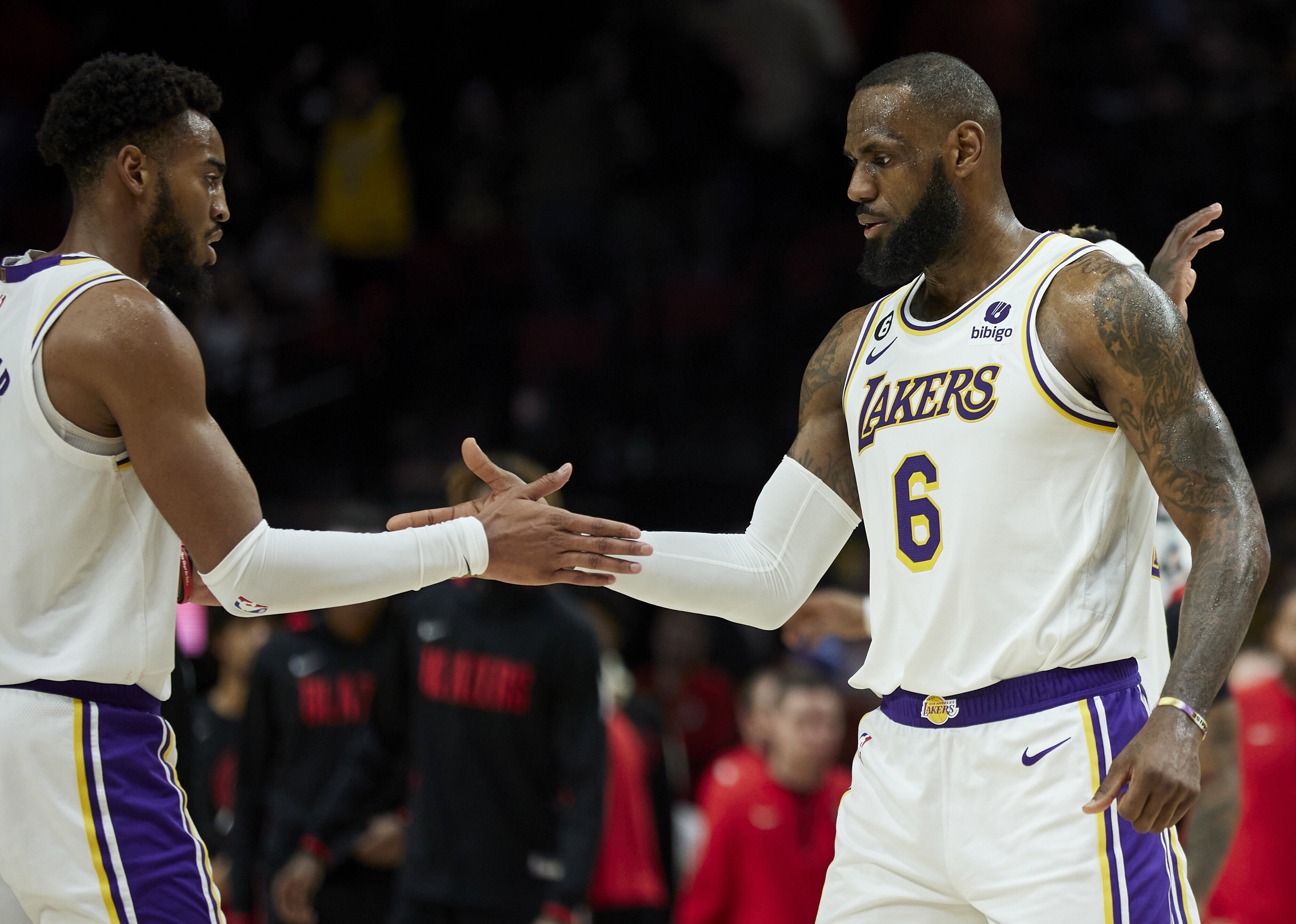 Los Angeles Lakers forward LeBron James, right, and forward Troy Brown Jr. celebrate after defeating the Portland Trail Blazers in an NBA basketball game in Portland, Ore., Sunday, Jan. 22, 2023.