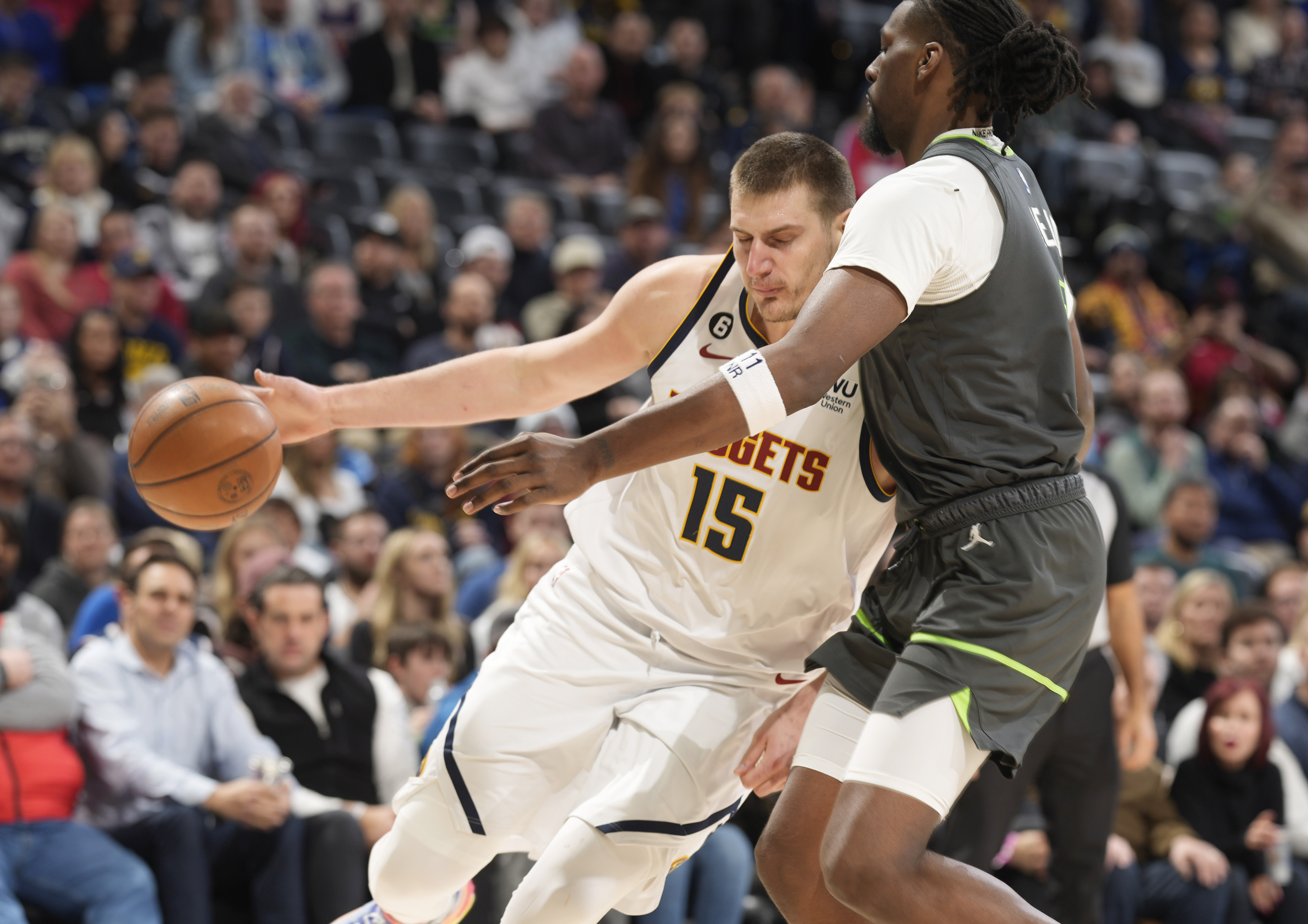 Denver Nuggets center Nikola Jokic, left, drives against Minnesota Timberwolves center Naz Reid during the second half of an NBA basketball game Wednesday, Jan. 18, 2023, in Denver. 