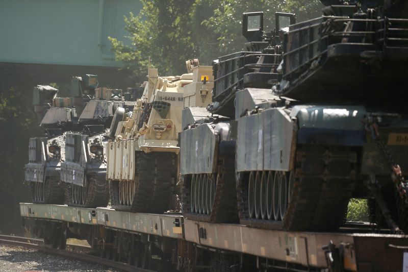 M1 Abrams tanks and other armored vehicles sit atop flat cars in a rail yard after President Donald Trump said tanks and other military hardware would be part of Fourth of July displays in Washington, July 2, 2019.