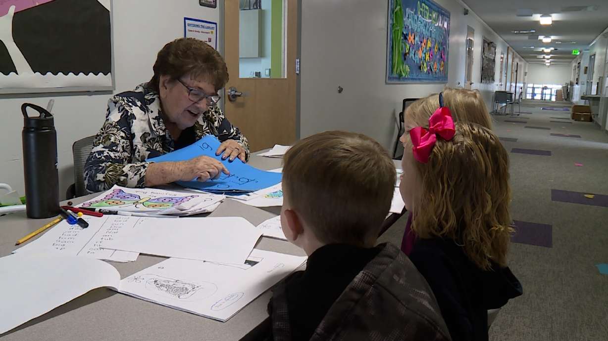 Arelene VanDyke helps advanced readers in kindergarten at Wasatch Elementary. VanDyke turned 90 years old this month.