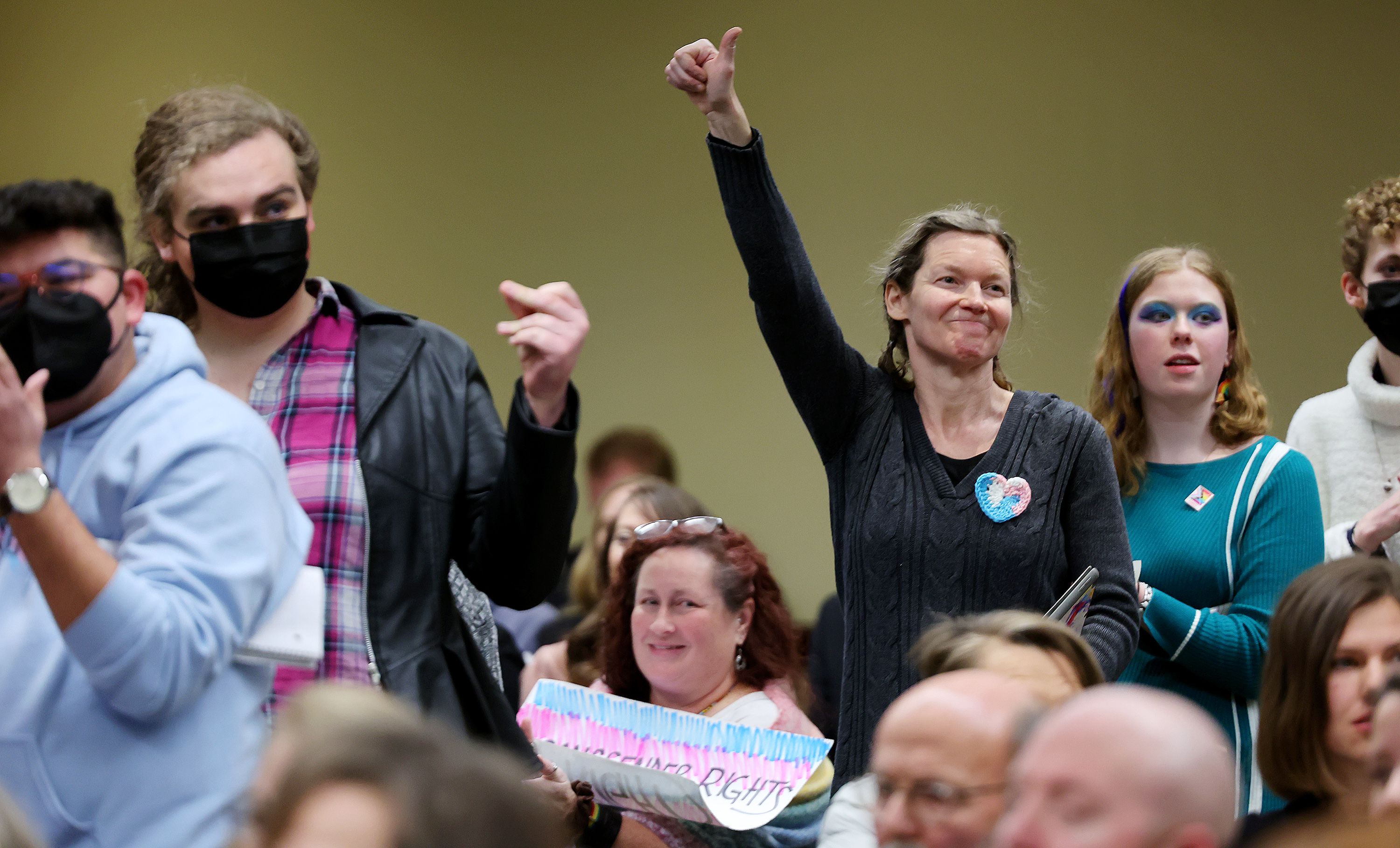 Crowd members who are against HB132 signal approval of comments as they attend the House Health and Human Services Standing Committee during hearings for HB132 and SB16 at the Capitol in Salt Lake City on Tuesday.