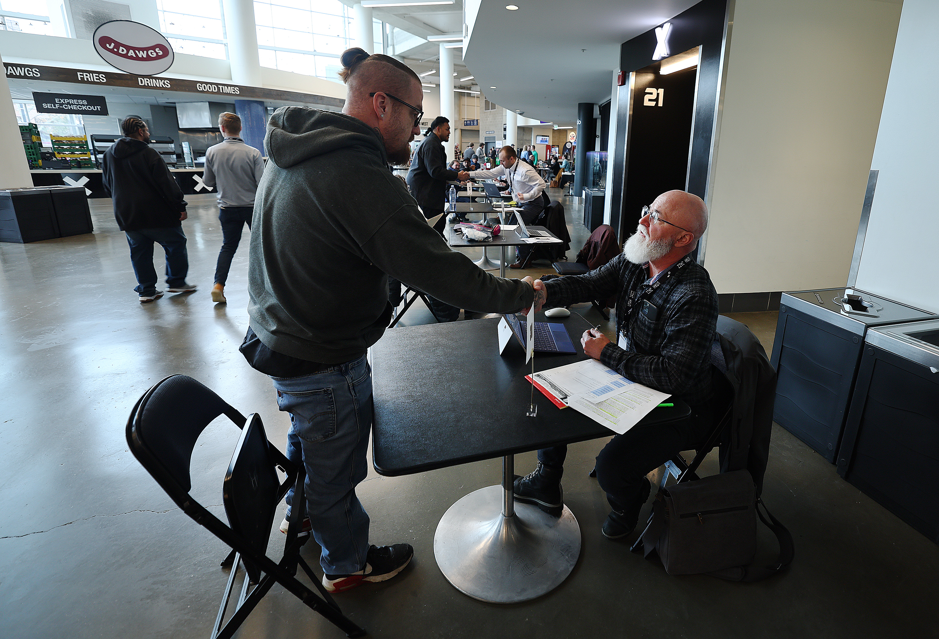Thomas Trujillo, shakes hands with attorney Curtis Grow, after having a legal discussion as hundreds gather at Vivint Arena to take part in the Clean Slate Summit free expungement clinic, in Salt Lake City on Tuesday.