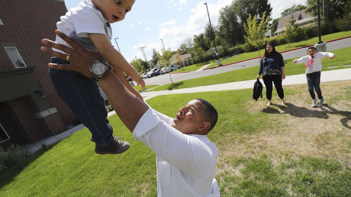 Carlos Moreno tosses his son Carlos Rodrigo as his wife, Norbelys, and son Carlos Isaias watch in Midvale on Sept. 9, 2019. Attendees urged members of the House Education Committee on Tuesday to adopt legislation that would extend in-state tuition rates at Utah's public colleges and universities.