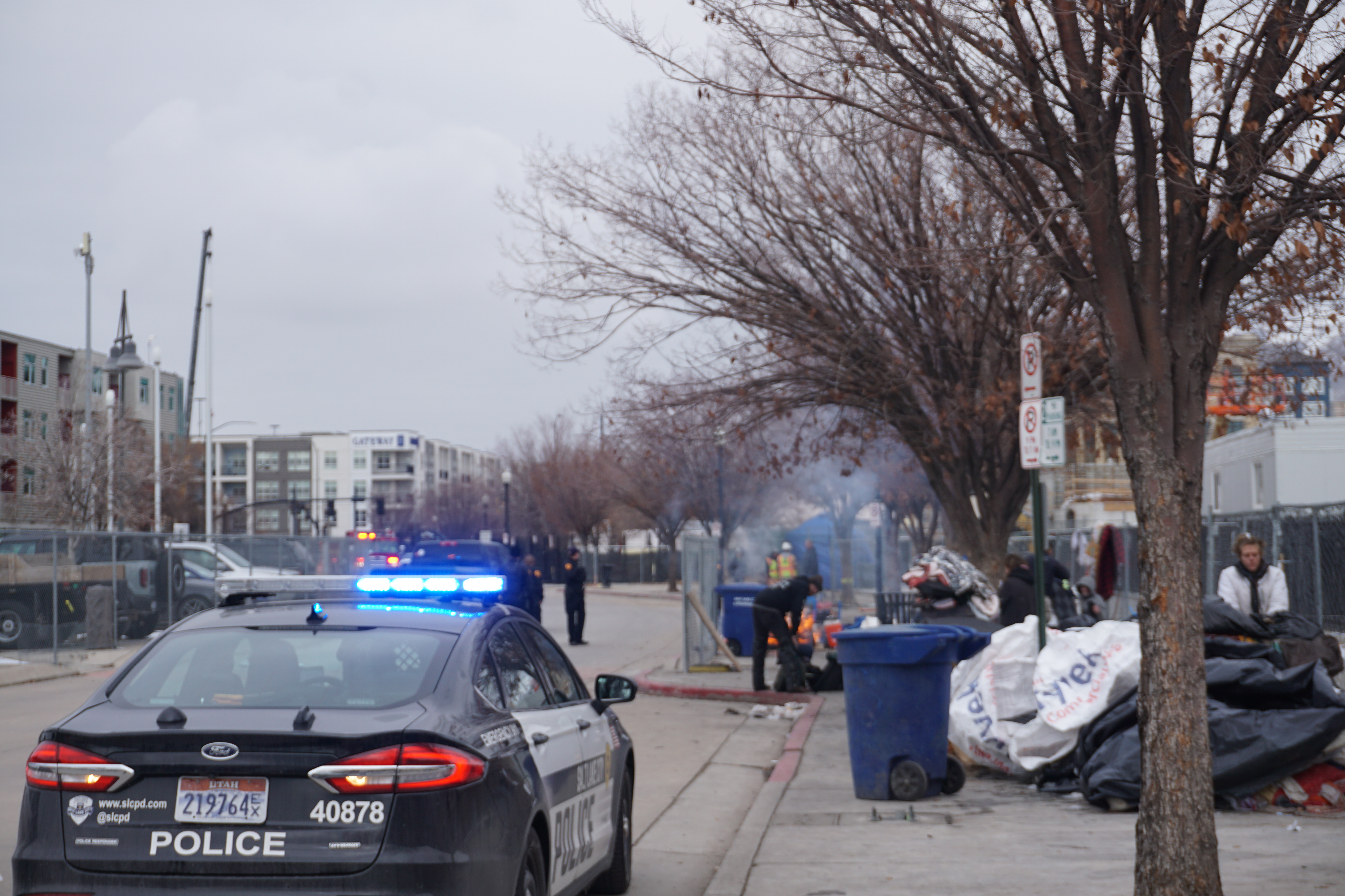 Salt Lake City police manage a fire during an abatement of a homeless camp on Tuesday. Unsheltered people camping near the Rio Grande Depot were notified they had an hour to remove their belongings and leave. Within the hour, bulldozers and dumpsters had arrived.
