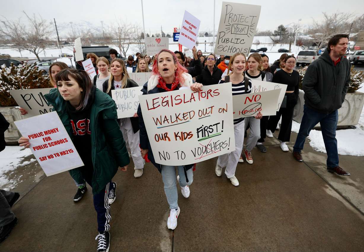 Elyse Arrington, a teacher at East High, walks out with students and teachers to oppose proposed school vouchers being considered by the legislature outside East High in Salt Lake City on Wednesday.