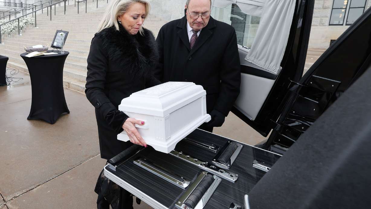 Mary Taylor carries a symbolic baby casket to a hearse during a Pro-Life Utah memorial service at the Capitol in Salt Lake City Wednesday, to honor the lives of 1,746 unborn babies that were aborted in Utah in 2022.