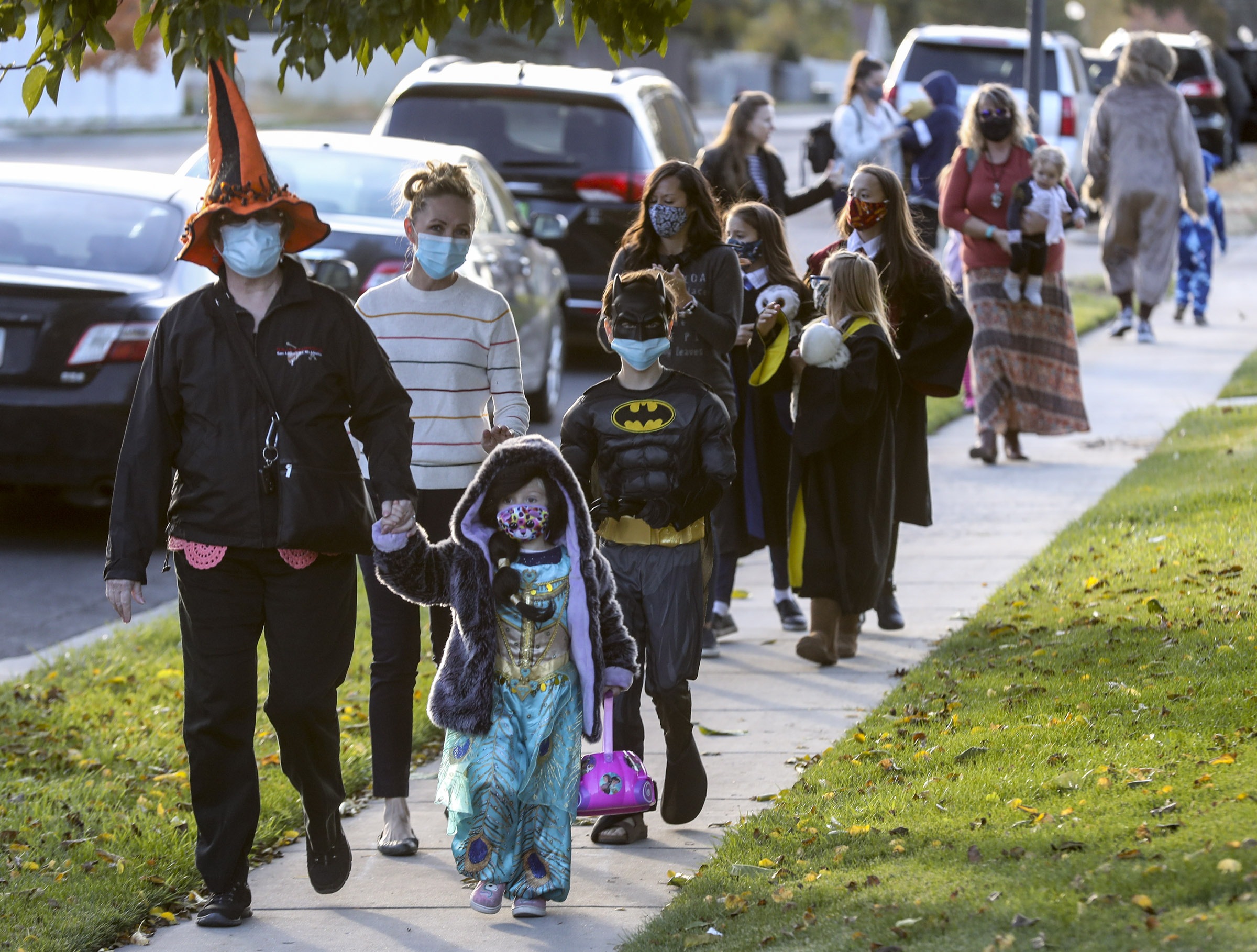 Parents and children parade through the Cedarwood senior living community during the community’s Halloween parade in Sandy on Oct. 22, 2020. A bill that would encourage Utah communities to bump Halloween festivities — like trick-or-treating — to the last Friday in October every year, passed out of a committee Wednesday and will go to the full Senate for a final vote.