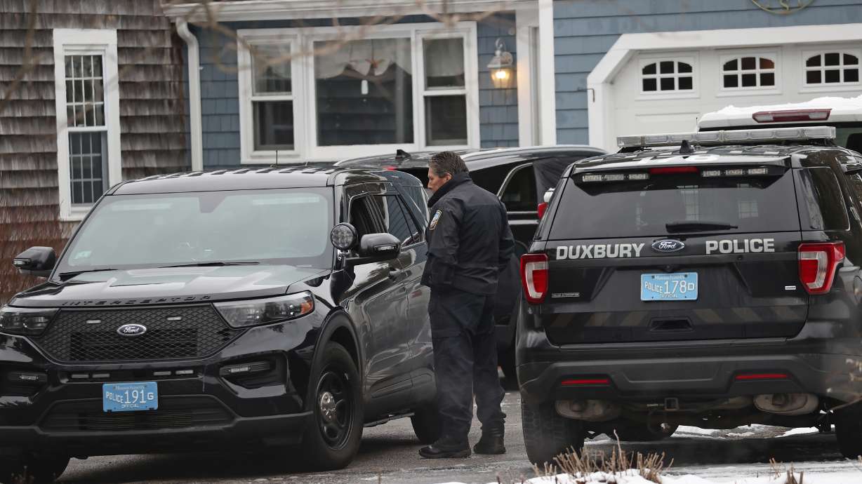 Duxbury police work at the scene where two children were found dead and an infant injured, Wednesday in Duxbury, Mass. A 32-year-old mother in Massachusetts is expected to be charged in the killing of her two children and the injuring of her infant son, officials say.