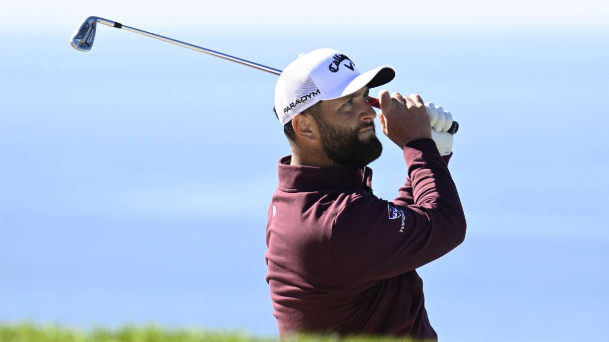 Jon Rahm, of Spain, watches his shot from a bunker on the fifth hole of the South Course at Torrey Pines during the first round of the Farmers Insurance Open golf tournament Wednesday, Jan. 25, 2023, in San Diego.