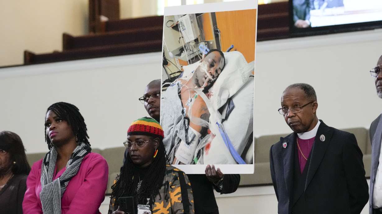 Family members and supporters hold a photograph of Tyre Nichols at a news conference in Memphis, Tenn., Monday. Five fired Memphis police officers have been charged with second-degree murder and other crimes in the arrest and death of Nichols, a Black motorist who died three days after a confrontation with the officers during a traffic stop.