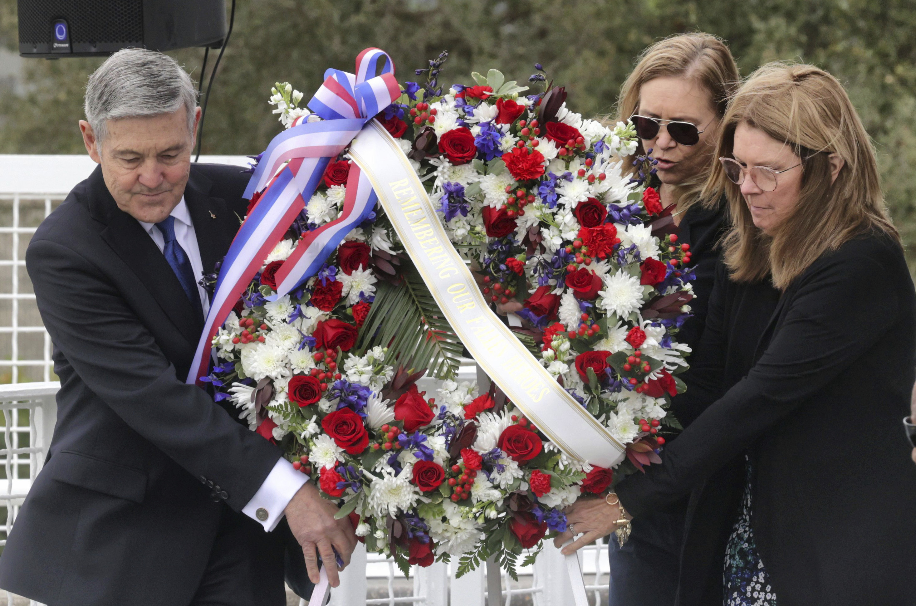 A wreath is presented by, from left, Bob Cabana, associate administrator of NASA; Janet Petro, NASA KSC director, and Sheryl Chaffee, daughter of Apollo 1 astronaut Roger Chaffee, during NASA's Day of Remembrance ceremony, Thursday.