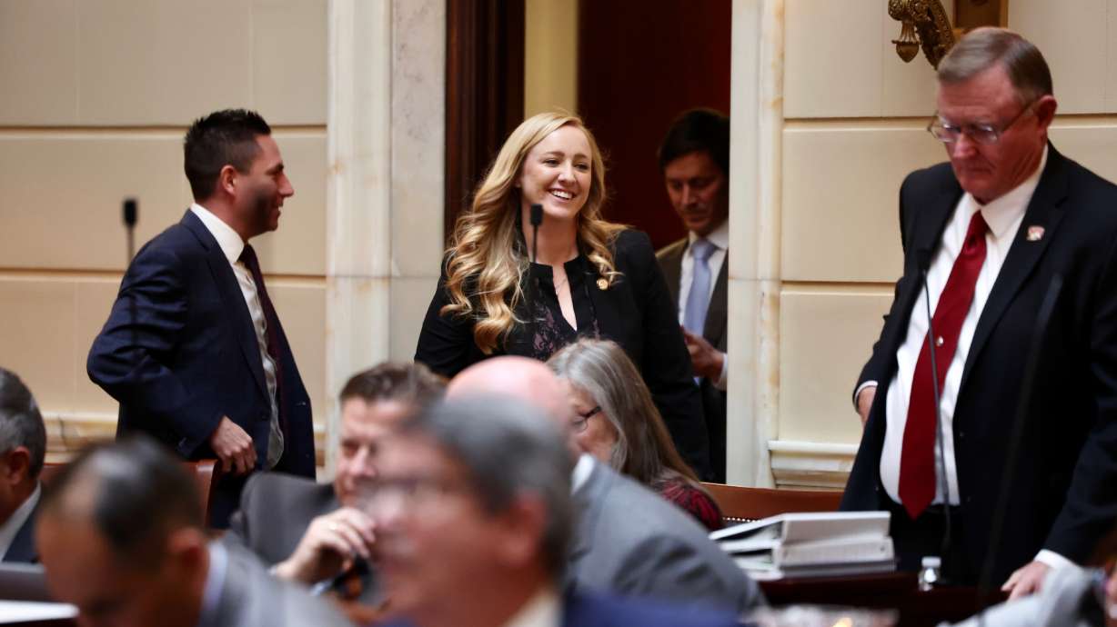 Rep. Candice Pierucci, R-Riverton, walks through Senate smiling after the school voucher bill passed on Thursday.