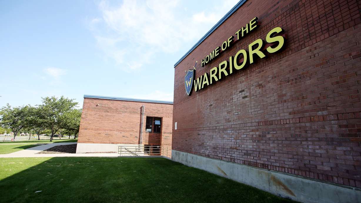 A suspended Taylorsville High School student has been arrested and accused of returning to the school and brandishing a gun in front of a group of students.