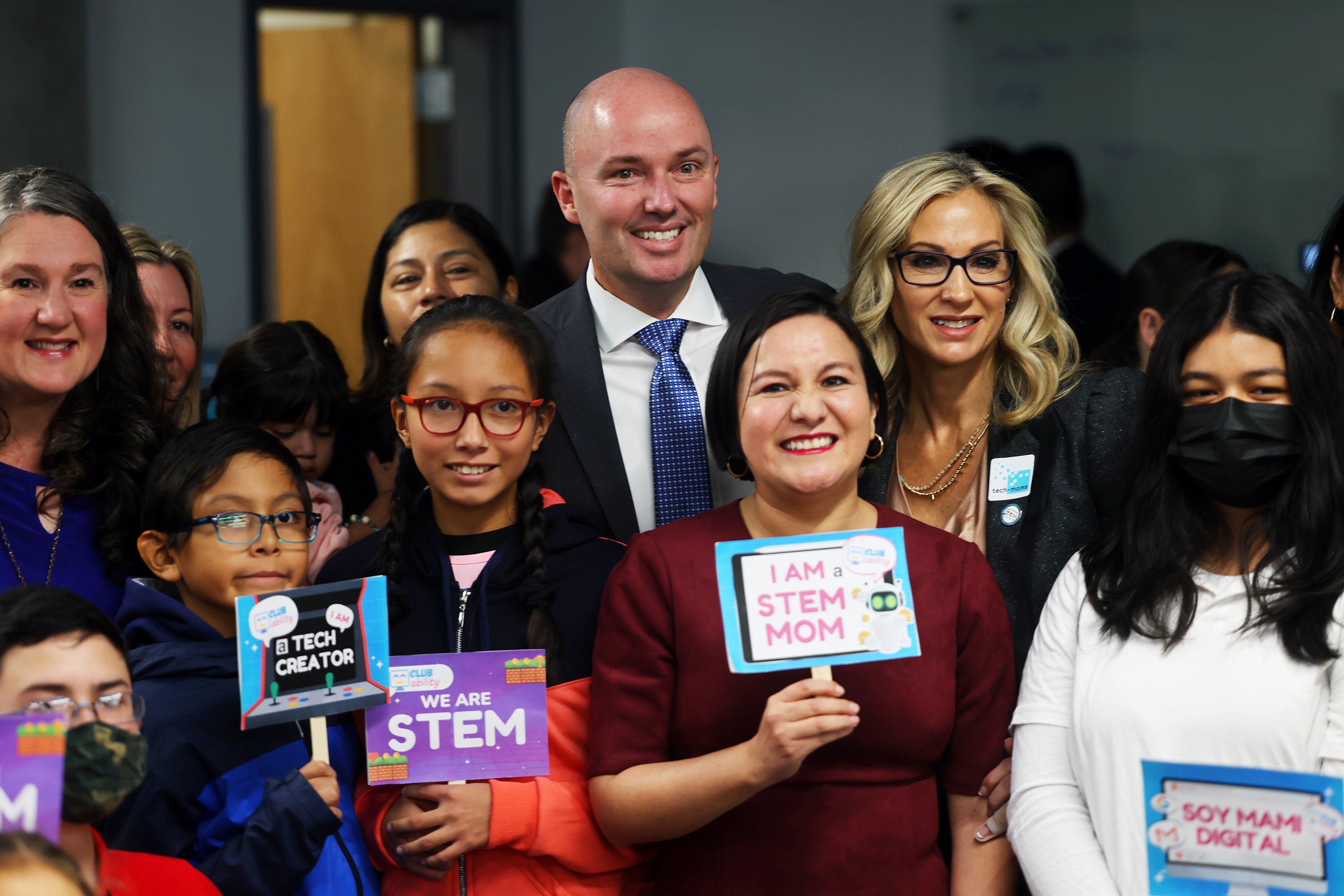 Club Ability founder Juliette Bautista Barahona, center, poses for a photo with Gov. Spencer Cox and students of her coding program for kids on Nov. 7, 2022. Bautista is expanding her nonprofit to help moms get involved in STEM.