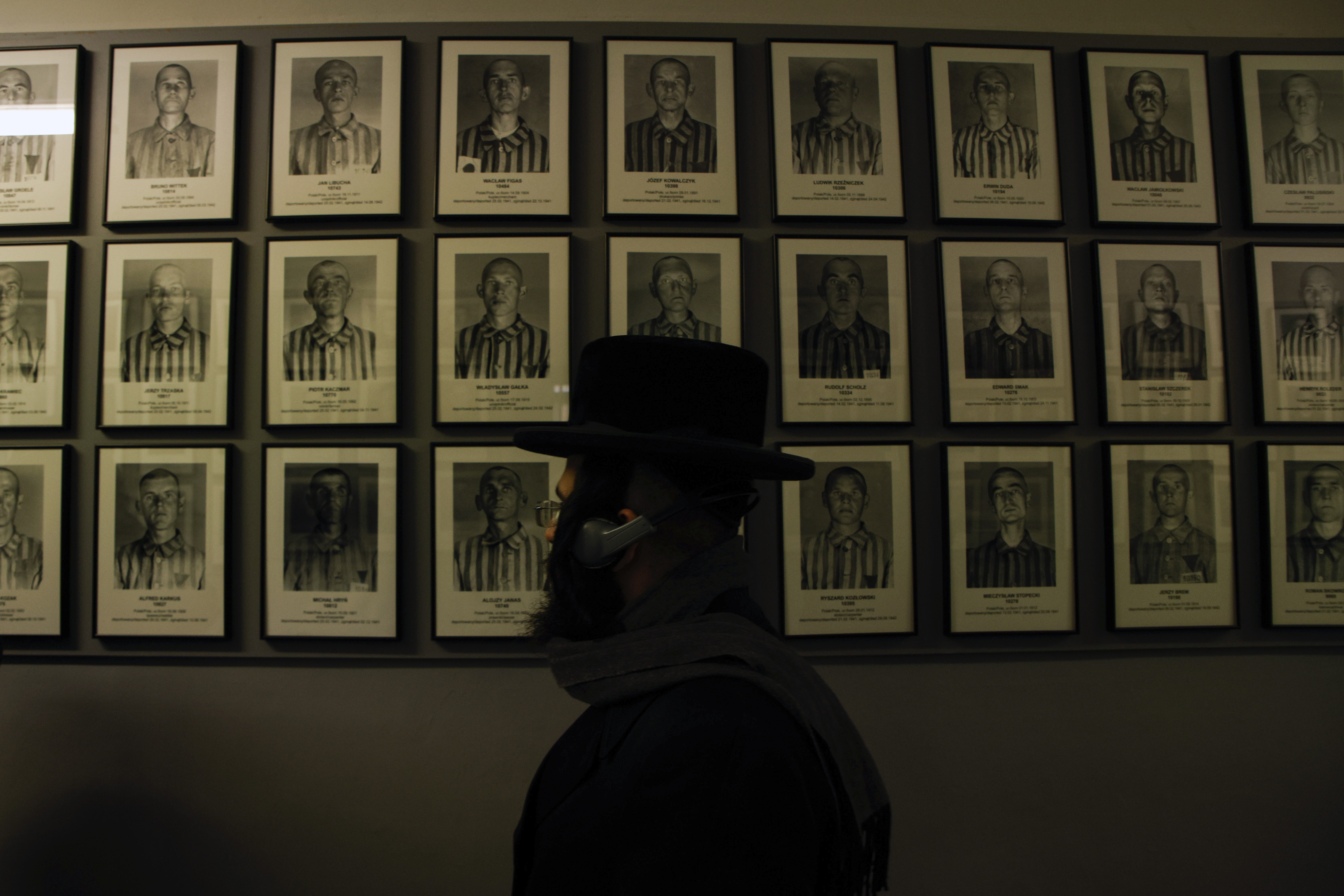 An orthodox Jew walks past the portraits of victims at the former Nazi German concentration and extermination camp Auschwitz-Birkenau in Oswiecim, Poland, on Jan. 27, the 78th anniversary of the camp's liberation.