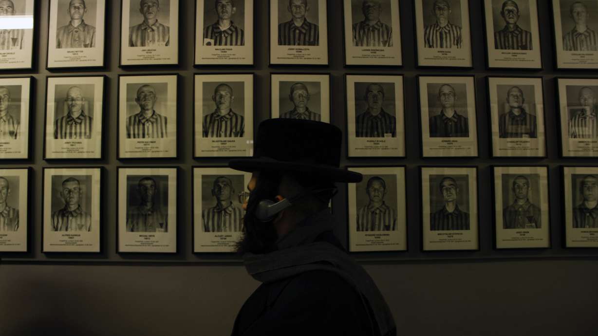 An orthodox Jew walks past the portraits of victims at the former Nazi German concentration and extermination camp Auschwitz-Birkenau in Oswiecim, Poland, on Jan. 27, the 78th anniversary of the camp's liberation.