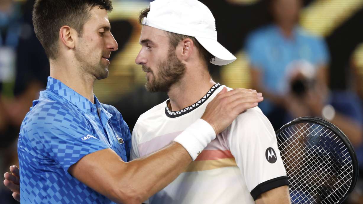 Novak Djokovic, left, of Serbia is congratulated by Tommy Paul of the U.S. after their semifinal at the Australian Open tennis championship in Melbourne, Australia, Friday, Jan. 27, 2023.