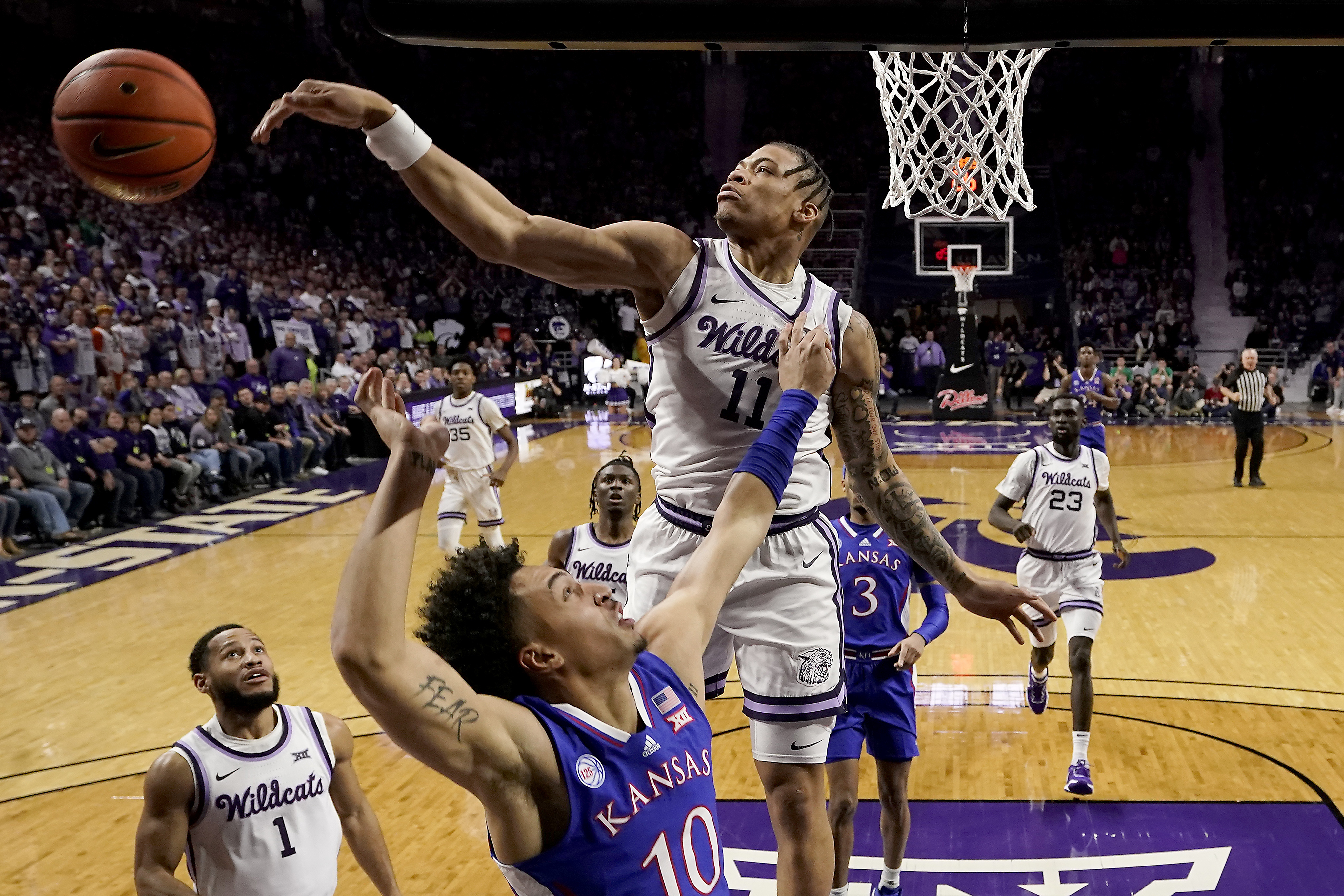 Kansas State forward Keyontae Johnson (11) blocks a shot by Kansas forward Jalen Wilson (10) during the first half of an NCAA college basketball game Tuesday, Jan. 17, 2023, in Manhattan, Kan. 