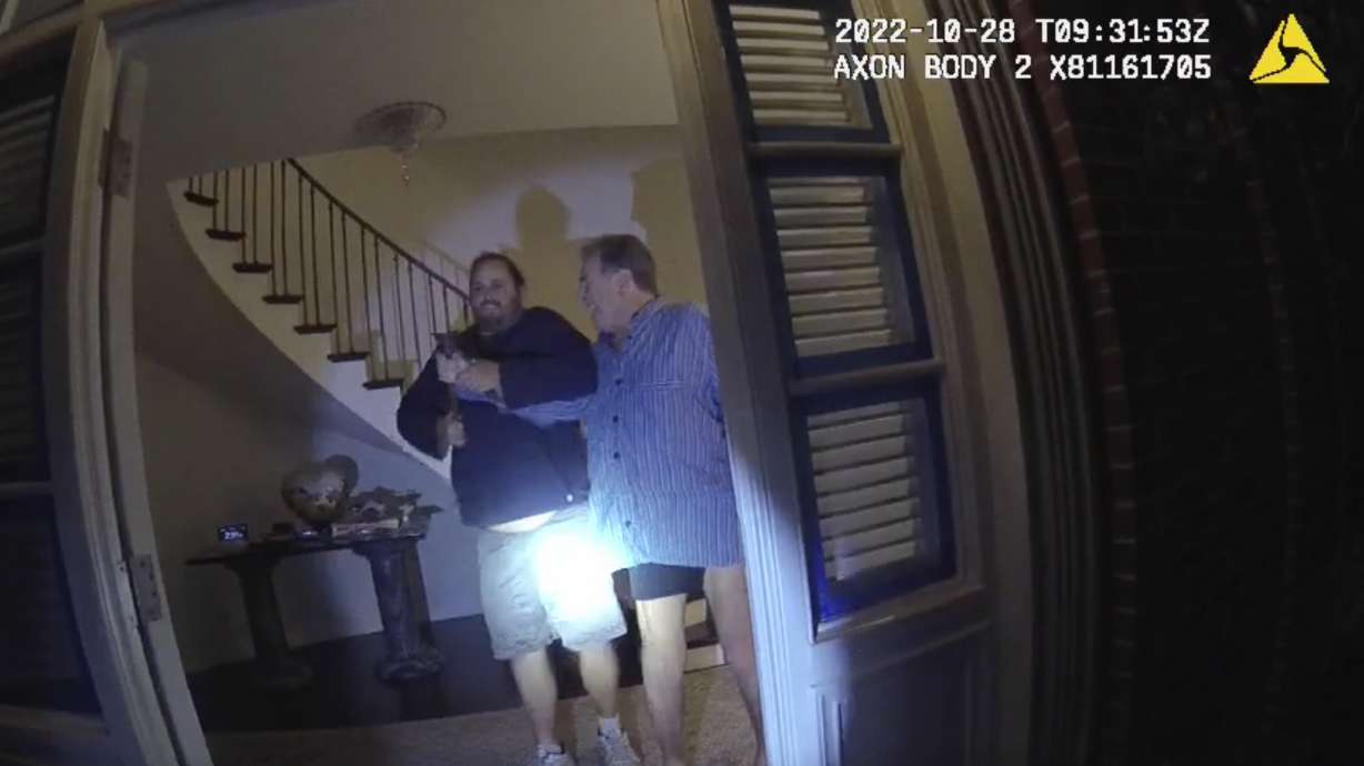 In this image taken from San Francisco Police Department body-camera video, the husband of former U.S. House Speaker Nancy Pelosi, Paul Pelosi, right, fights for control of a hammer with his assailant during a brutal attack in the couple's San Francisco home on Oct. 28, 2022. The video was released on Friday.