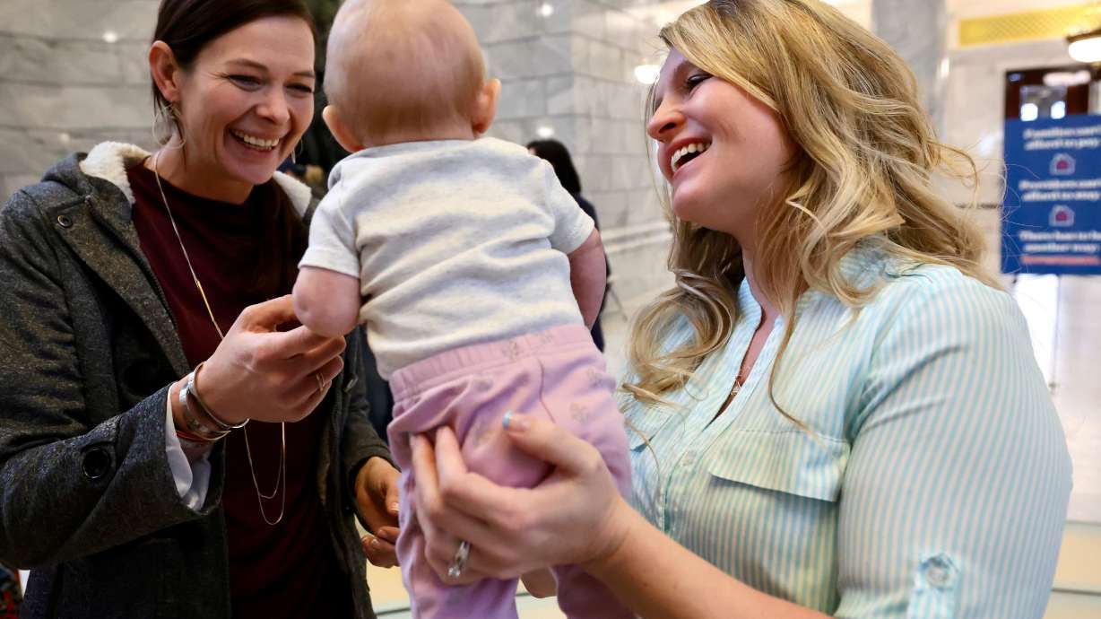 Child care provider Holly Kingston, of West Jordan, holds her daughter Haisley as she talks with Ilse Wilson, another child care provider, during the “Child Care Day on the Hill” event on Friday at the Capitol.