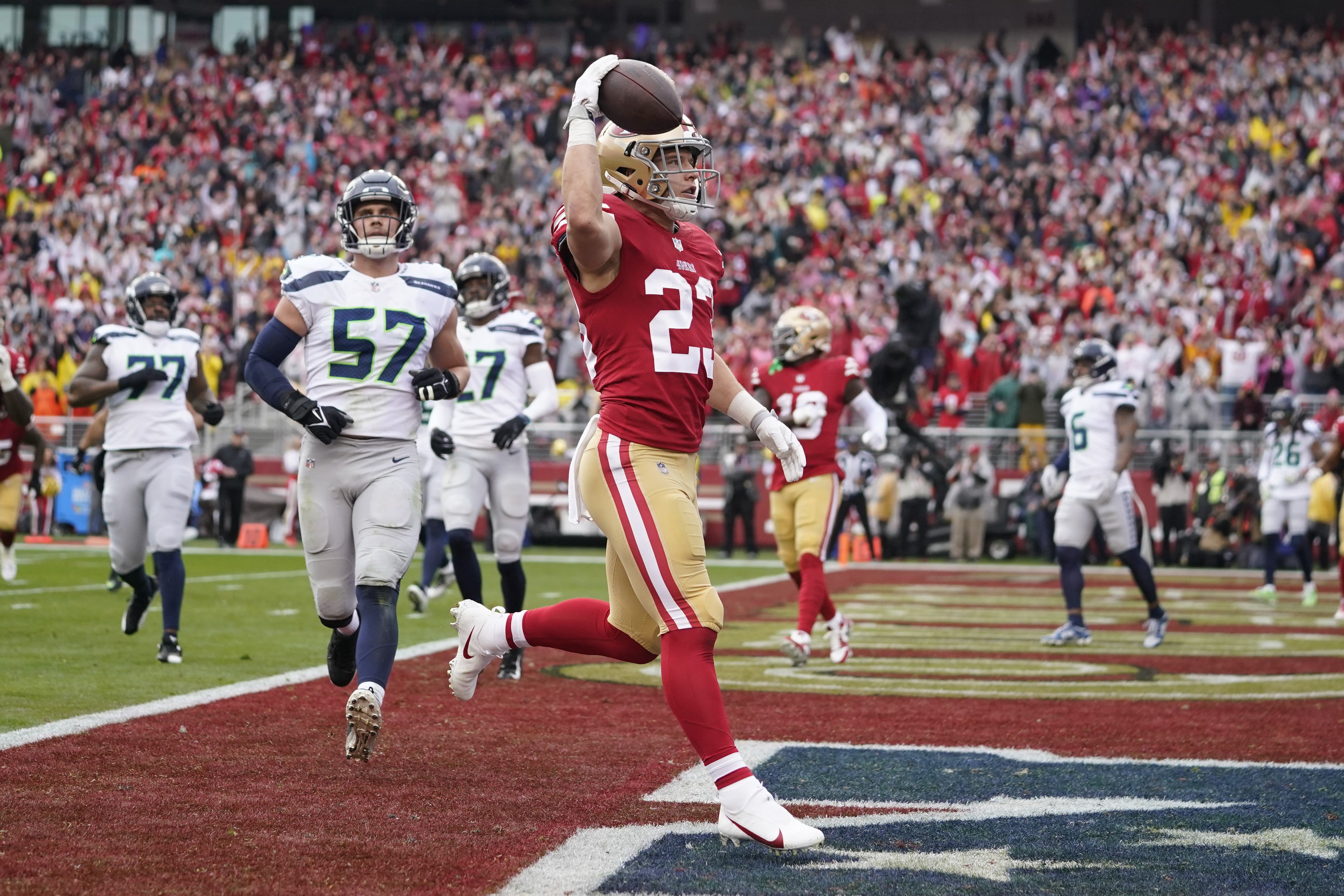 FILE - San Francisco 49ers running back Christian McCaffrey (23) celebrates after scoring a touchdown against the Seattle Seahawks during the first half of an NFL wild-card playoff football game in Santa Clara, Calif., Jan. 14, 2023. New York Giants running back Saquon Barkley, McCaffrey and Seattle Seahawks quarterback Geno Smith are the finalists for AP Comeback Player of the Year. 