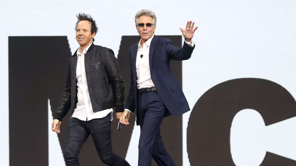 Bill McDermott, former CEO of software company SAP, right, reacts to the applause as he is introduced by Qualtrics co-founder and former CEO Ryan Smith, left, during the Qualtrics X4 Summit at the Salt Palace Convention Center in Salt Lake City on March 7, 2019.