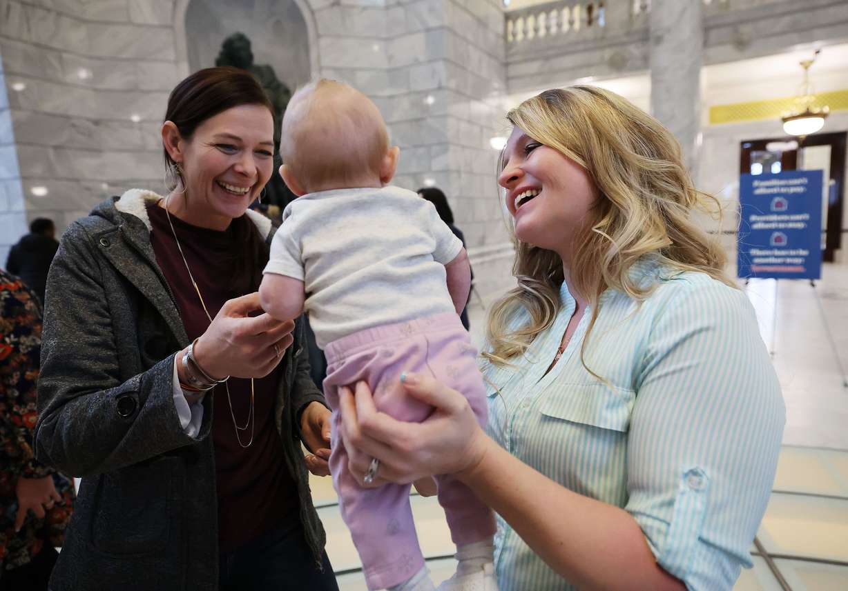 Child care provider Holly Kingston holds her daughter Haisley and talks with Ilse Wilson in the Rotunda at the Capitol in Salt Lake City on Friday. Parents, children, educators and supporters gathered at the Capitol for Child Care Day on the Hill.